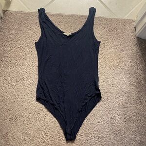 Navy bodysuit with seam down the middle, small v cut on neckline is intentional